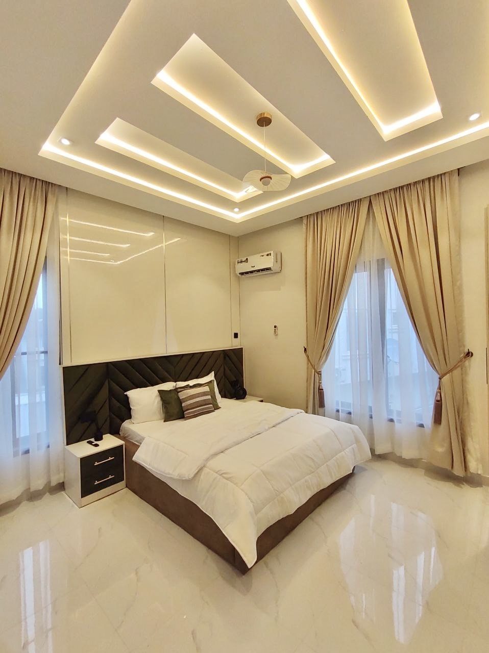Bedroom with layered ceiling lighting, Apartment Alpha, Nimbus Nook Ikeja GRA