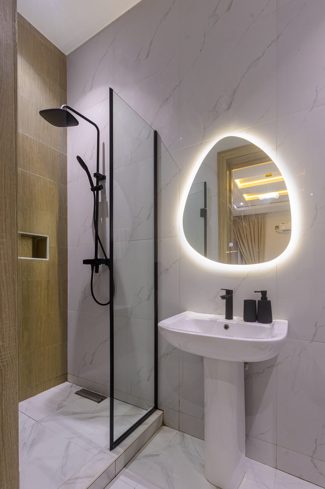 En-suite bathroom with illuminated mirror, Apartment Bravo, Nimbus Nook shortlet in Ikeja GRA