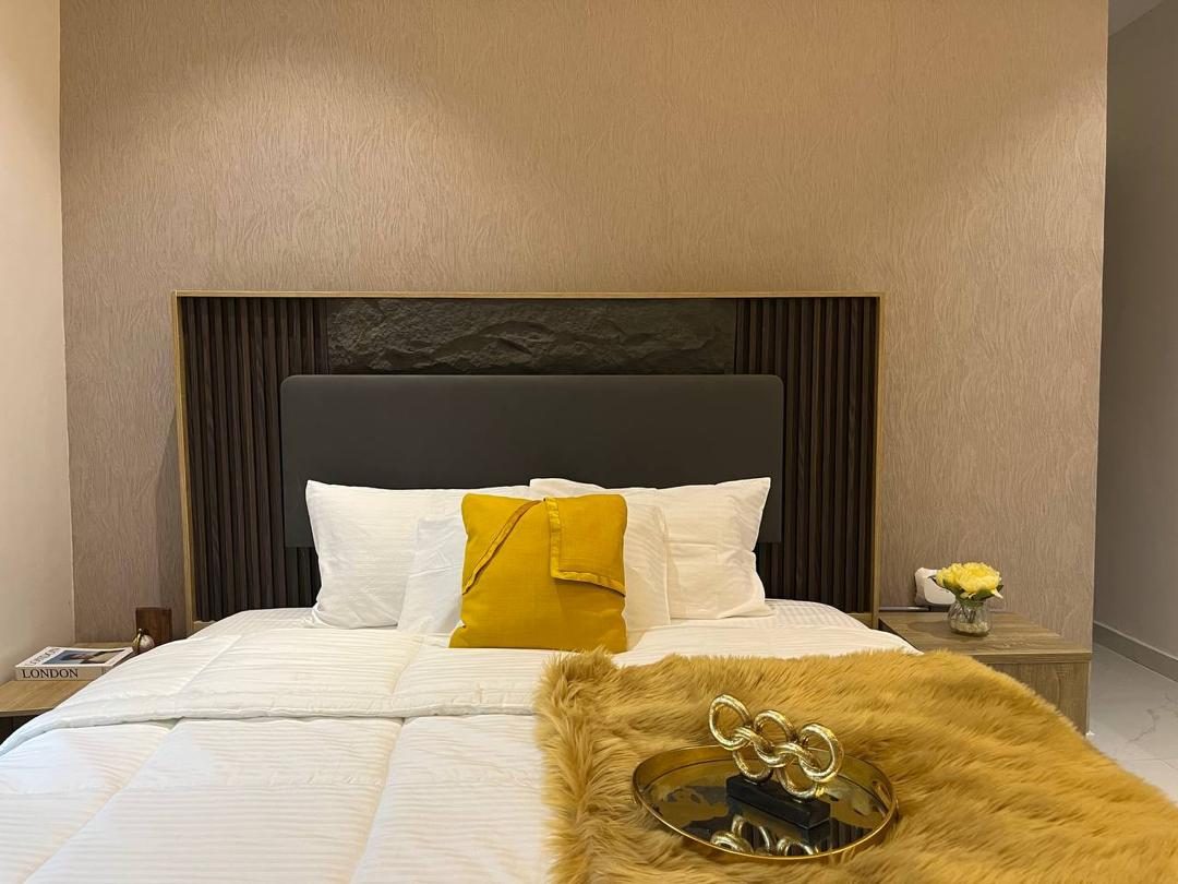 Bedroom with fluted headboard, Apartment Bravo, Nimbus Nook shortlet in Ikeja GRA