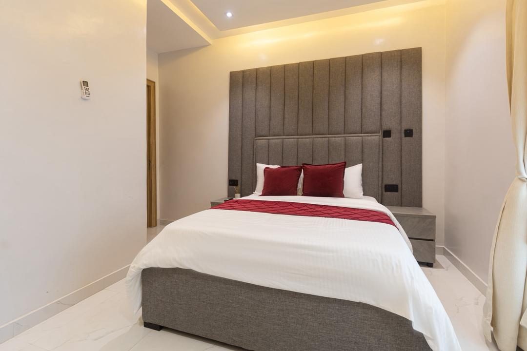 Bedroom with upholstered headboard, Apartment Charlie, Nimbus Nook shortlet in Ikeja GRA