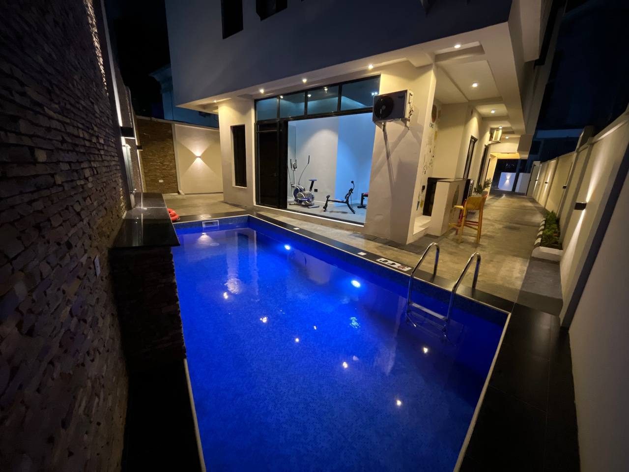 Swimming pool lit at night at Nimbus Nook, Ikeja GRA